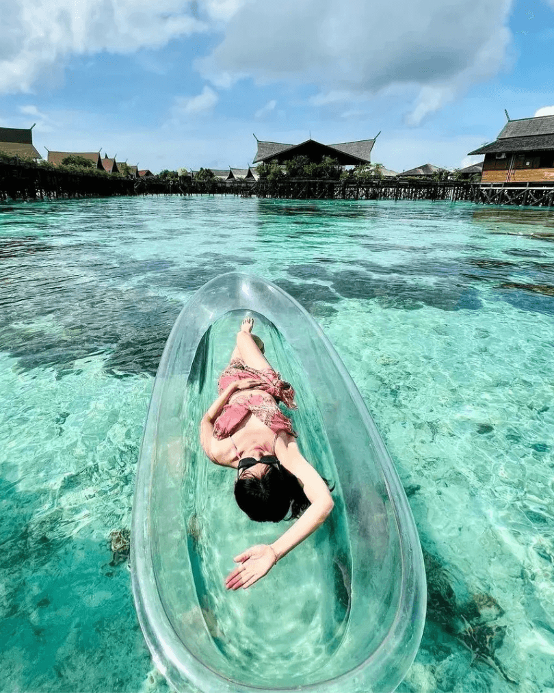 Clear kayak floating on shallow turquoise water in Malaysia