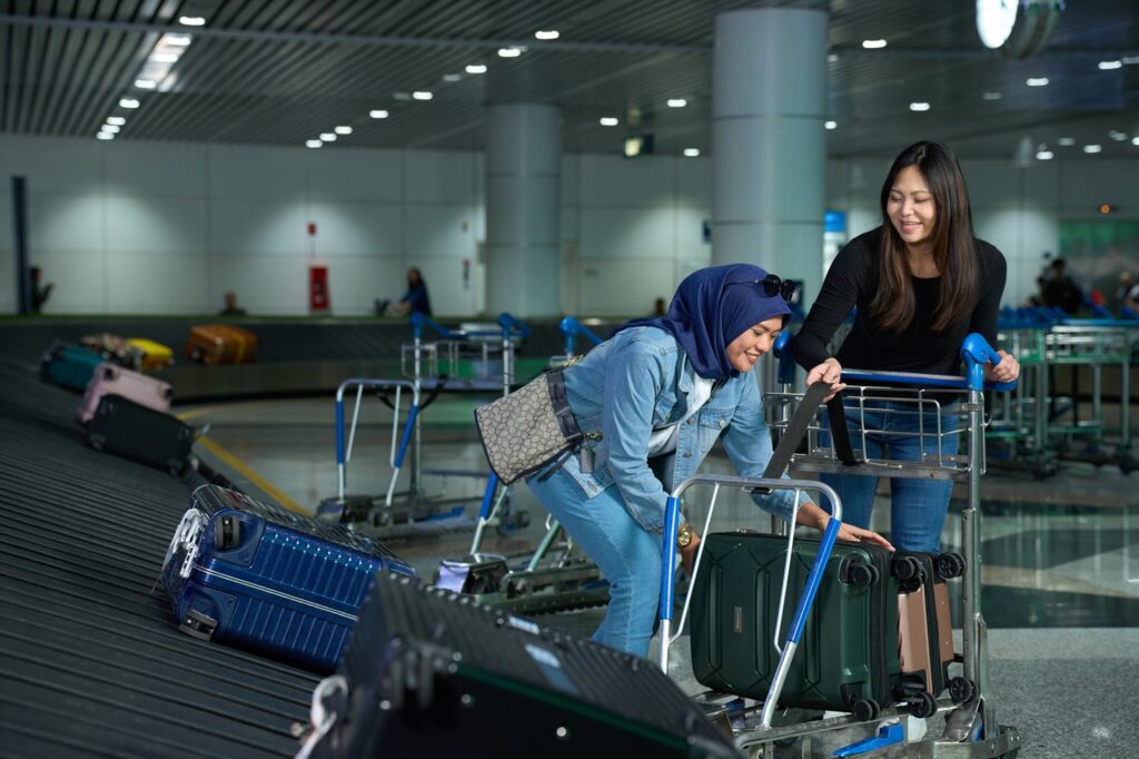 International travellers collecting luggage at a Malaysia airport